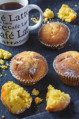 Muffins with coffee on dark background