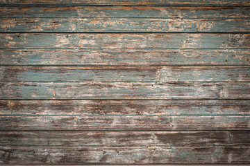 A wooden background. The peeled-down tarnished green paint on the old boards.