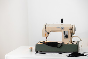 Beige sewing machine the process of sewing a protective medical mask at home is handmade