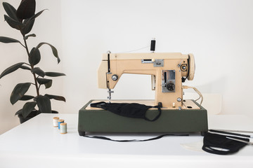 Beige sewing machine the process of sewing a protective medical mask at home is handmade