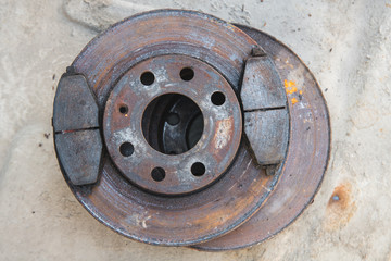 old brake pads on the brake disc with a shallow depth of field