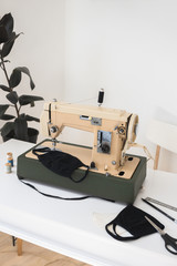 Beige sewing machine the process of sewing a protective medical mask at home is handmade