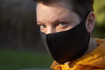 Middle aged european woman in protective black mask, woman wearing mask during coronavirus COVID-19 Epidemic. Sick woman wearing protection during pandemic.