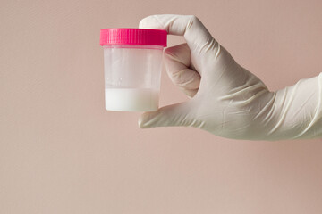 Sperm donation. Tests in the hands of the doctor. A hand in a glove.