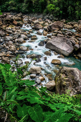 the beautiful scenic waterfall in front of famous double decker root bridge in meghalaya