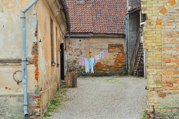 Laundry is dried in the fresh air. Inner courtyard in a small Latvian town.
