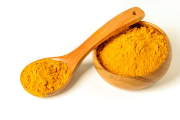 Turmeric powder in wooden spoon and bowl on the white background closeup isolated. Healing spice, health care concept.
