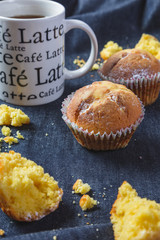 Muffins with coffee on dark background