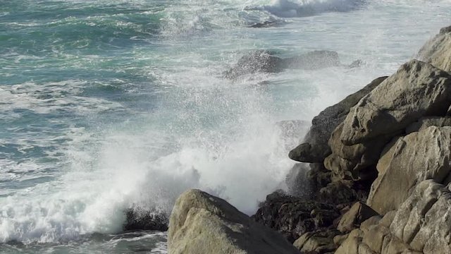 ocean wave crashes on rocks
