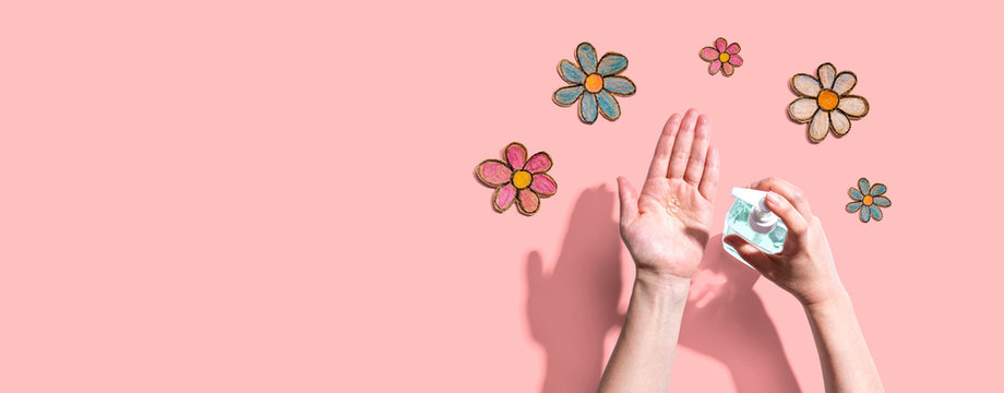 Applying Sanitizer Gel For Cleaning Hands With Flower Drawings