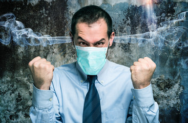 Portrait of a furious man wearing a mask, coronavirus concept
