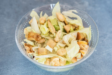 Caesar salad with toast, lettuce and grilled chicken breast