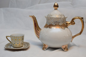 Mock up / design set of elegant and traditional teapot colorful white blue gold coffee cup & Tea cup on cup's plate beside the hot tea pot , design/ drink-ware isolated on white background