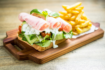 Rolled ham sandwich with fresh dill sauce