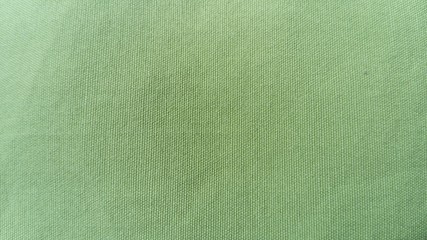 Light green woven coarse material, similar to canvas, linen or thick cotton. Thick fabric for...