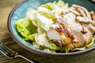 Caesar salad with grilled chicken breast, green