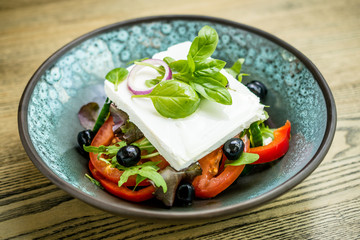 Salad with goat feta cheese, tomatoes, olives