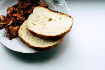 Mushrooms and bread in a white plate