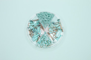 Office clips and binders on a turquoise background