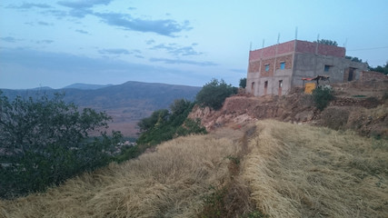 Fototapeta premium view from the top of the hill, mountains, yellow grass, trees, house, traditional, natural