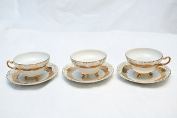 Mock up / design set of elegant and traditional teapot colorful white blue gold coffee cup & Tea cup on cup's plate beside the hot tea pot , design/ drink-ware isolated on white background