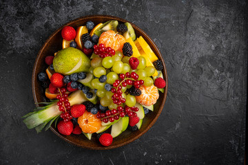 assorted fruit plate on dark background
