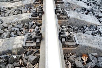 railway wooden sleepers. fastening the rails to the sleepers with bolts.