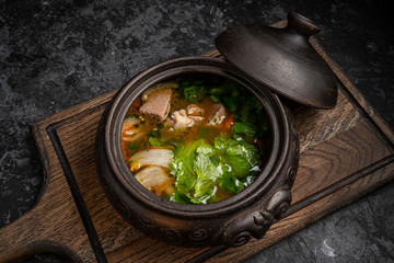 Eggplant grilled with rice and cheese on a black plate. Top view. Rustic style.