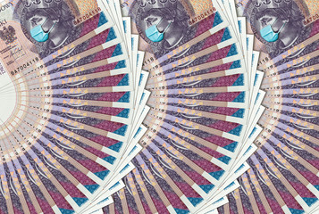 Coronavirus in Poland. Quarantine and global recession. 20 Polish zloty banknote with face mask against infection. Global economy hit by covid19.National Bank of Poland prints money to save bugdet