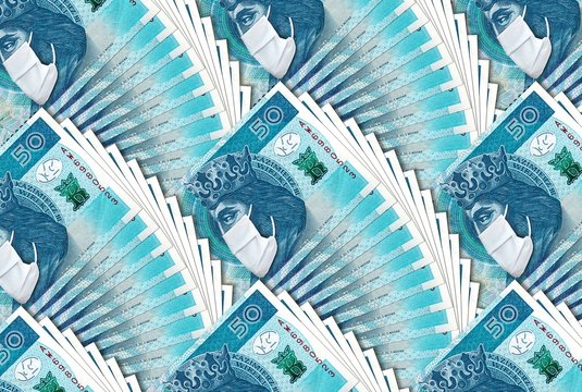 Polish banknote 50 zloty with face mask against Coronavirus pandemic. National Bank of Poland prints bilions zlotych to save Polish economy and prevent country from recession.