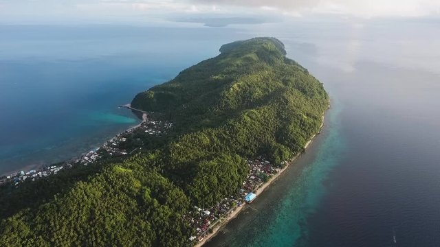 Aerial view of a beautiful tropical island surrounded with turquoise blue water. Limasawa Island, Southern Leyte, Philippines.