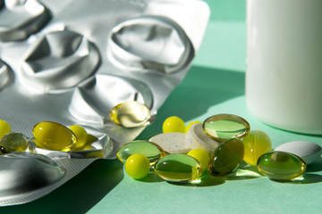 Spreading tablet of various shapes and colors, transparent yellow, large white. A bunch of pills....