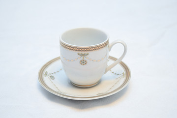 Mock up / design set of elegant and traditional teapot colorful white blue gold coffee cup & Tea cup on cup's plate beside the hot tea pot , design/ drink-ware isolated on white background