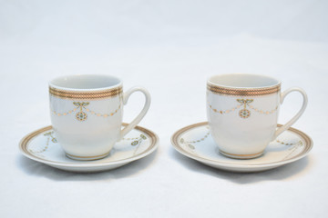 Mock up / design set of elegant and traditional teapot colorful white blue gold coffee cup & Tea cup on cup's plate beside the hot tea pot , design/ drink-ware isolated on white background