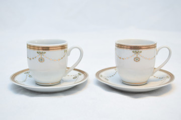 Mock up / design set of elegant and traditional teapot colorful white blue gold coffee cup & Tea cup on cup's plate beside the hot tea pot , design/ drink-ware isolated on white background