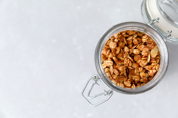 Oatmeal granola cereal in open glass jar