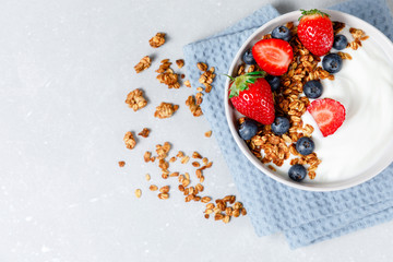 Homemade oatmeal granola bowl with greek yogurt, berries, honey and nut
