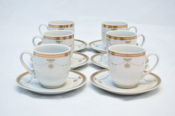 Mock up / design set of elegant and traditional teapot colorful white blue gold coffee cup & Tea cup on cup's plate beside the hot tea pot , design/ drink-ware isolated on white background