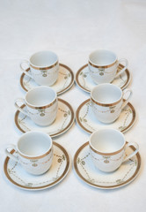 Mock up / design set of elegant and traditional teapot colorful white blue gold coffee cup & Tea cup on cup's plate beside the hot tea pot , design/ drink-ware isolated on white background