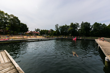 Fototapeta na wymiar Pople relaxing at the lake next to Giżycko city, Mazury, Poland.