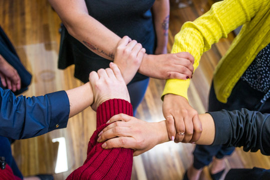 Group Of Business People Holding Hands