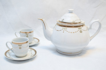 Mock up / design set of elegant and traditional teapot colorful white blue gold coffee cup & Tea cup on cup's plate beside the hot tea pot , design/ drink-ware isolated on white background