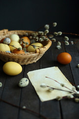 yellow and brown Easter eggs in a basket on a wooden background