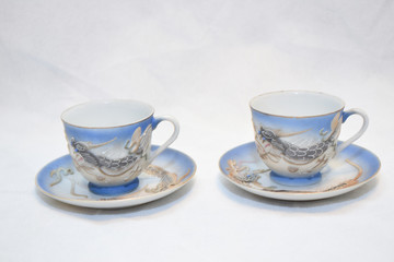 Mock up / design set of elegant and traditional teapot colorful white blue gold coffee cup & Tea cup on cup's plate beside the hot tea pot , design/ drink-ware isolated on white background