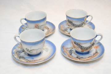 Mock up / design set of elegant and traditional teapot colorful white blue gold coffee cup & Tea cup on cup's plate beside the hot tea pot , design/ drink-ware isolated on white background