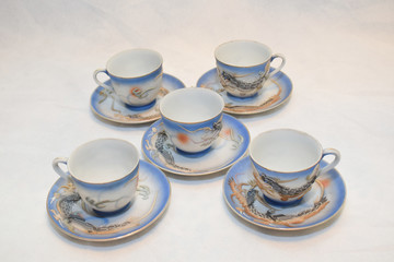 Mock up / design set of elegant and traditional teapot colorful white blue gold coffee cup & Tea cup on cup's plate beside the hot tea pot , design/ drink-ware isolated on white background