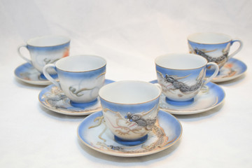 Mock up / design set of elegant and traditional teapot colorful white blue gold coffee cup & Tea cup on cup's plate beside the hot tea pot , design/ drink-ware isolated on white background