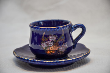 Mock up / design set of elegant and traditional teapot colorful white blue gold coffee cup & Tea cup on cup's plate beside the hot tea pot , design/ drink-ware isolated on white background