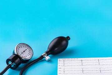 Tonometer, device for measuring blood pressure, cardiogram on a blue background. Close up. Place to...