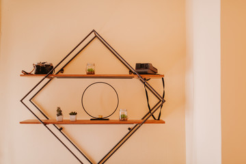 A shelf in a room with decorations and old cameras